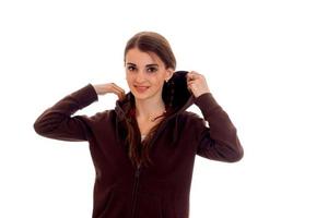 young beautiful brunette lady with red lips in brown sport clothes posing and looking at the camera isolated on white background photo