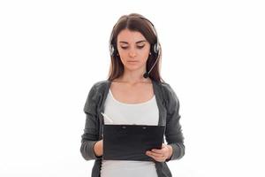 young adorable brunette business woman with headphones and microphone make notes isolated on white background photo