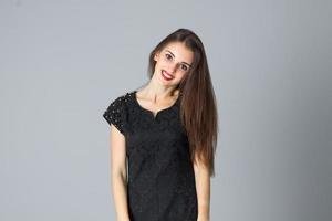 girl in black dress posing in studio photo