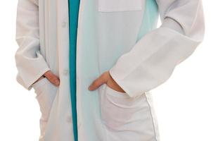 a doctor in a white coat put hands in pockets close-up isolated on white background photo