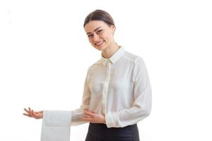 a charming young girl-waiter invites guests to the table with a cloth on hand photo