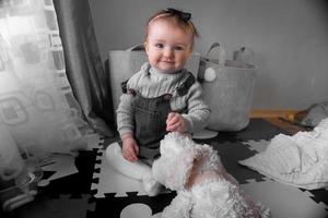 Charming little baby girl smiles at home photo