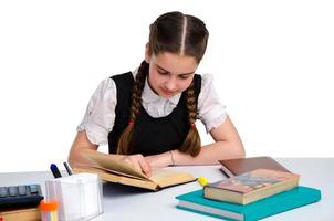 young schoolgirl in unform studying photo