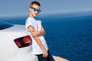 young stylish boy in sunglasses photo