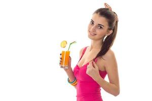 lovely young lady with dark hair in pink summer shirt drink orange cocktail and smiling isolated on white background photo