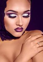 Studio portrait of beauty girl with purple make up photo