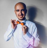 Elegance man in shirt and bowtie smiling on camera photo