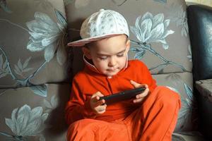 young boy in red suit and cap photo