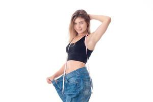 Slim girl wearing large pants and keeping his hand over head isolated on white background photo