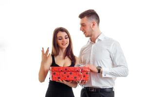 a man gives a woman a big red gift photo