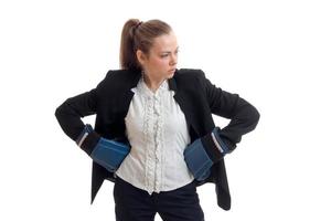 serious sexy business girl posing in Studio in boxing gloves and jacket with shirt photo