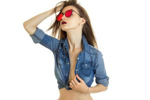 Sensual lady in sunglasses and jeans shirt without bra under photo