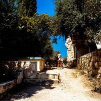 girl walks through the ruins of ancient Greece photo