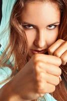 Close up portrait of caucasian woman in boxing stance photo