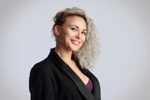 Woman in studio smiling on camera photo