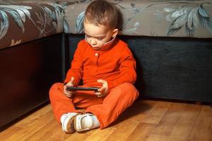 Serious young boy playing games photo