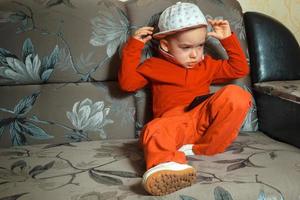 young boy in red suit and cap photo