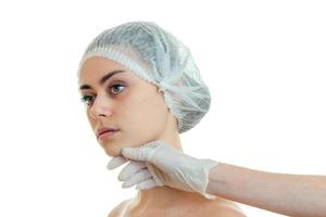 horizontal portrait of a young girl in the medical CAP which turned her head aside in a cabinet with a doctor photo