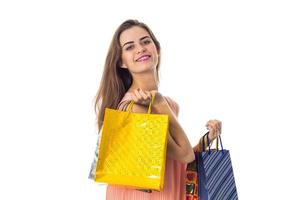 girl stretches forward big bright packages with gifts is isolated on a white background photo