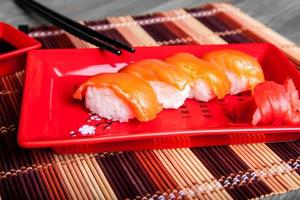 Sushi with salmon on red plate photo