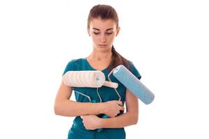 young cute girl holding rollers for painting photo