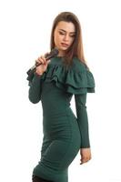 charming brunette in green dress with microphone in hands photo