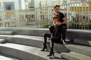 hermosa pareja joven posando en las escaleras de la ciudad foto