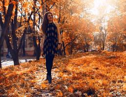 niña en madera de otoño con letra de hoja roja foto