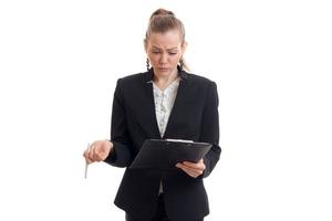 beautiful young business Lady in a suit looking at Tablet and wrinkled her face photo