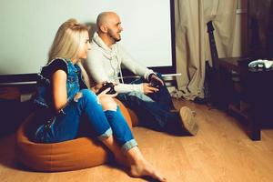 Portrait of young beautiful couple having fun and playing games photo