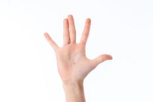 mano femenina estirada con los dedos levantados y palmas aisladas en fondo blanco foto