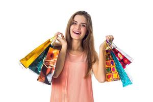 good beautiful girl keeps two hands many packages with gifts is isolated on a white background photo