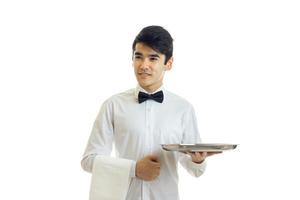 young smiling waiter shirt holding a tray of crockery photo