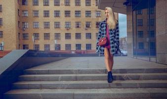 Beauty blonde fashion model walking around the street and looking away photo