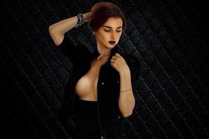 Sexual young brunette girl with big breast in studio photo