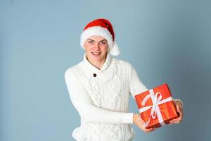 young man with gift box in hands photo