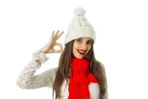 brunette girl in warm sweater and red scarf photo