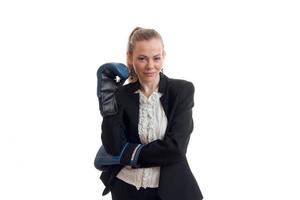 amazing young blonde in black suit stands in front of the camera holding hands in boxing gloves and smiling photo