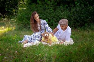 happy family plays with their liitle baby daughter at the green meadow photo