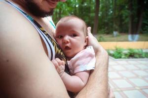 lindo bebé en los brazos de papá foto