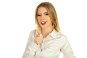 girl winks and points at the camera in a studio photo