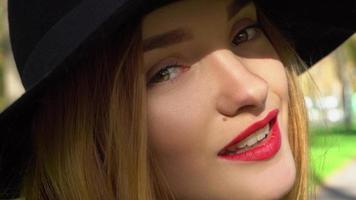 girl in hat with wide brim and with red lips photo