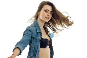 Portrait of chic young girl with beautiful hair in jeans jacket and brassiere photo