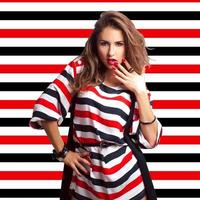 Nice brown hair girl on stripes background in studio photo