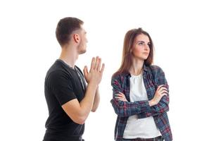 young guy asks forgiveness from girl and she turned away from him photo