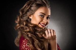 Charming young girl with beautiful curly hairstyle photo