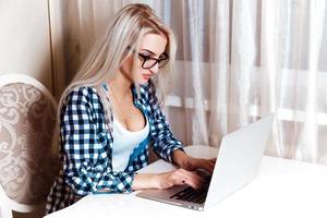 Photo of beautiful young blonde woman with laptop computer