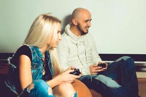 Boyfriend having fun and playing computer games with his girlfriend photo