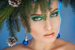 Beautiful girl with wreath on head. Christmas time photo