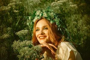 miling woman with wreath on head photo